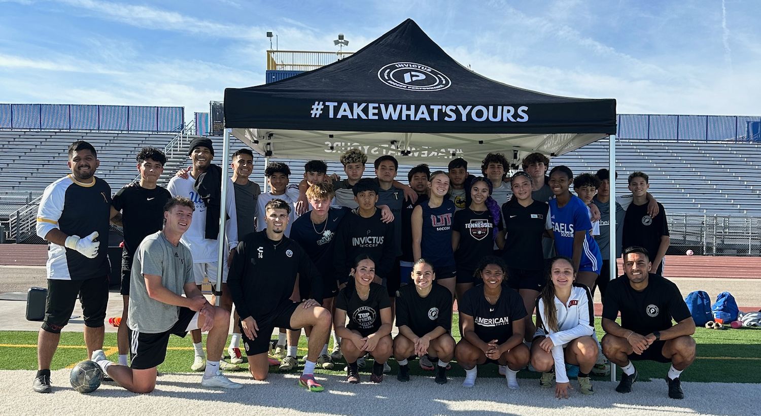 Invictus players and coaches together under the Invictus tent after a training session