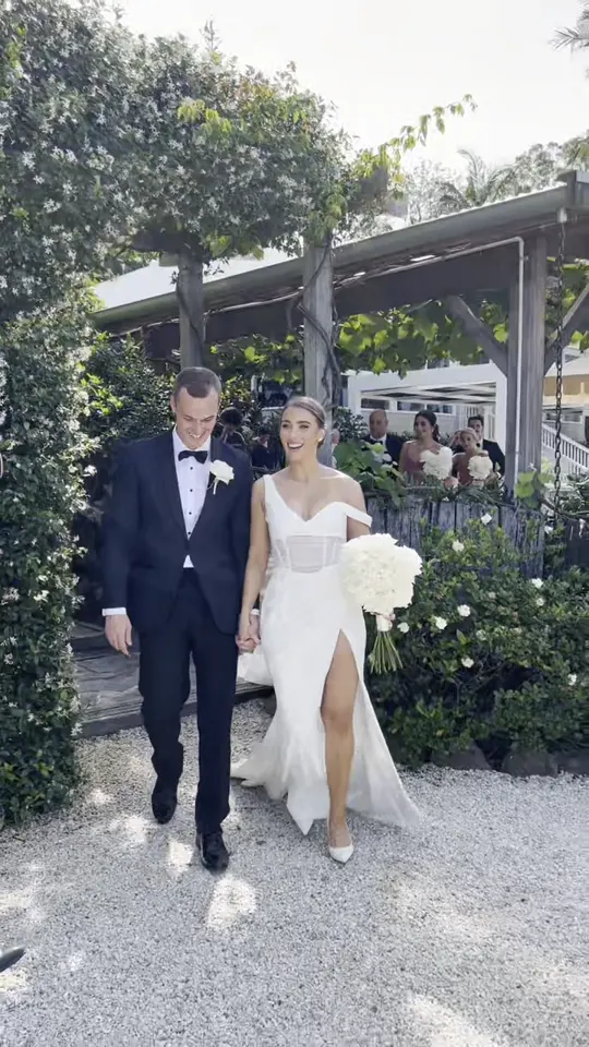 Chloe and Luke walking through the garden