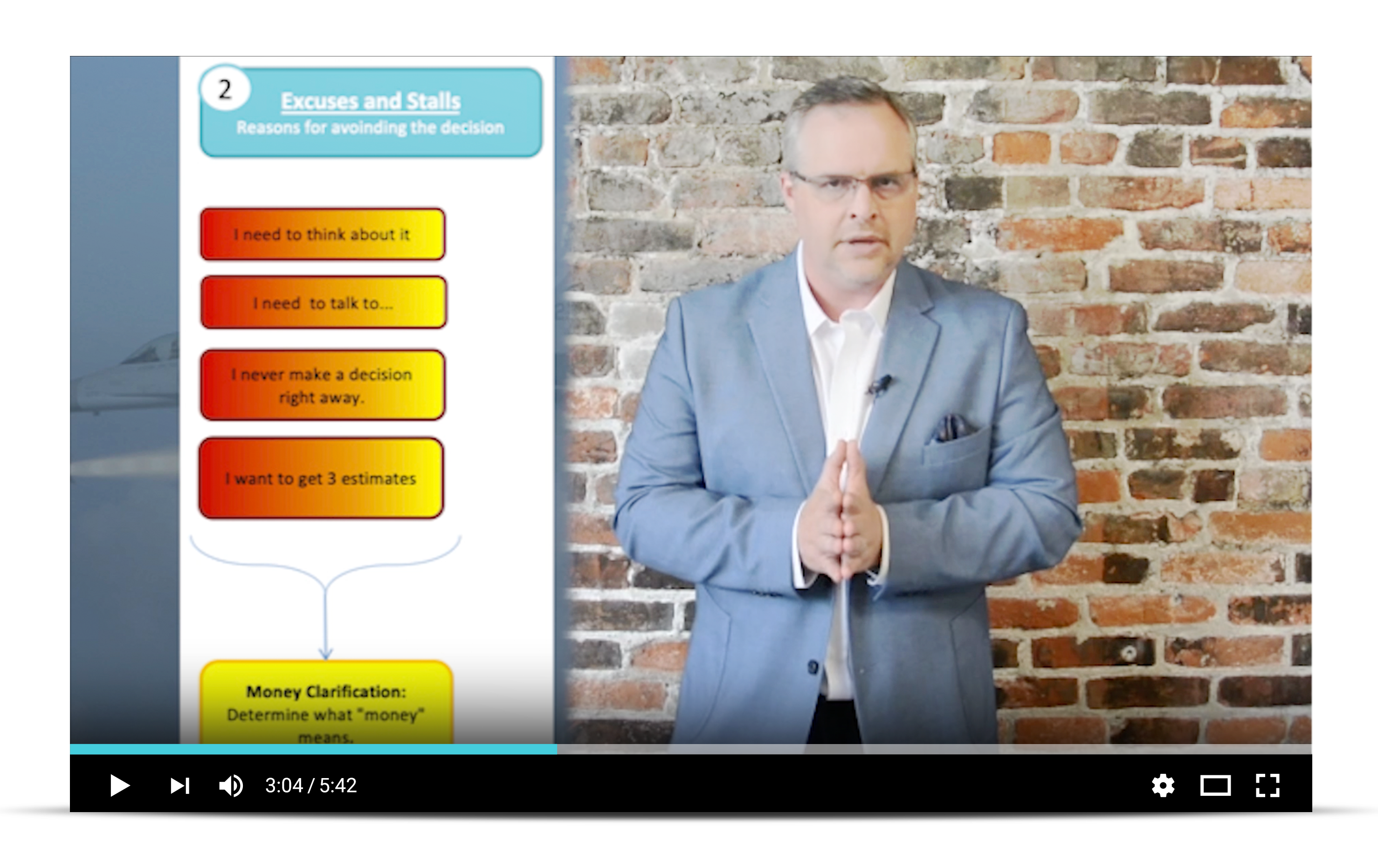 A man in a suit stands before a screen displaying a diagram of a business plan, emphasizing a professional setting.