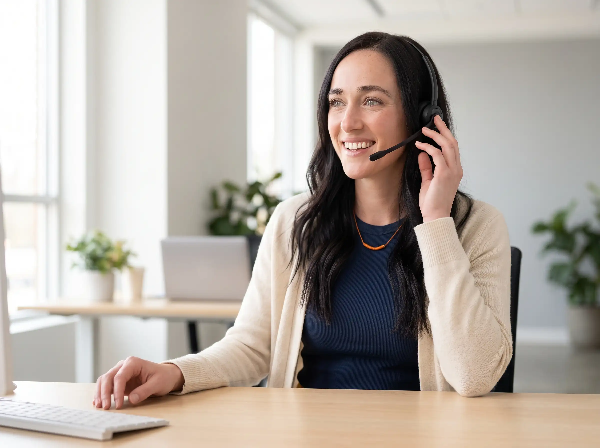 Jill's Office receptionist on a headset answering a customer call at her desk
