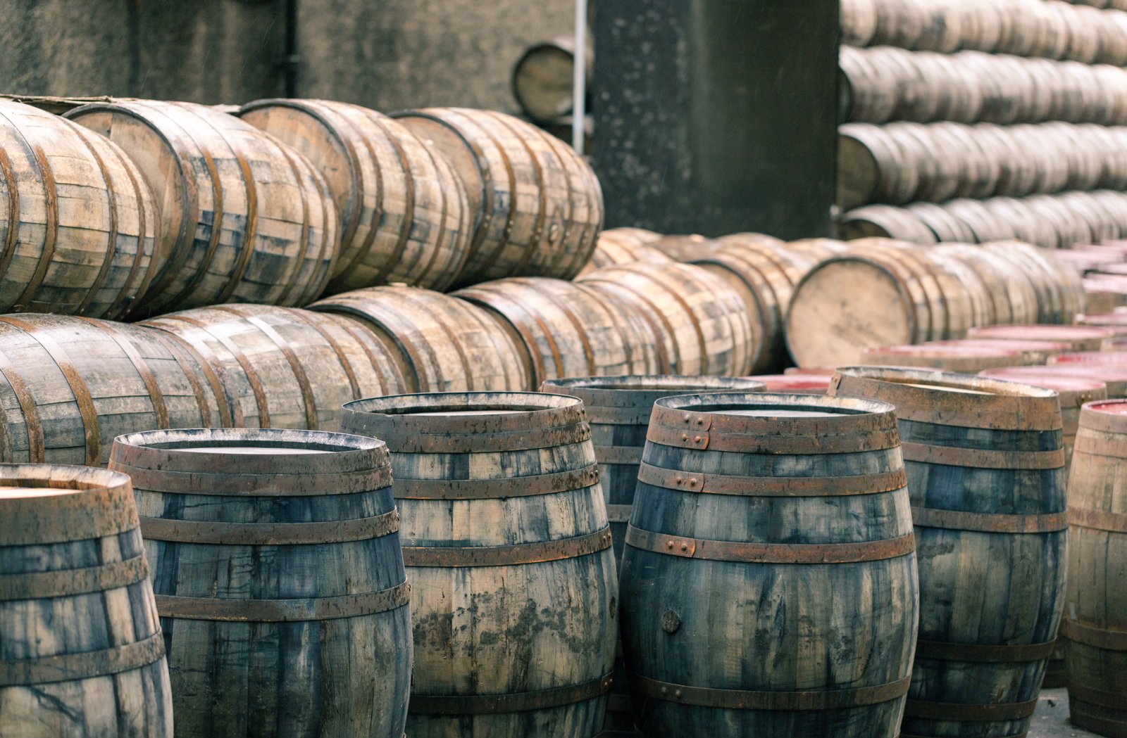 Casks resting in a Scottish warehouse, where scarcity is produced by time rather than marketing