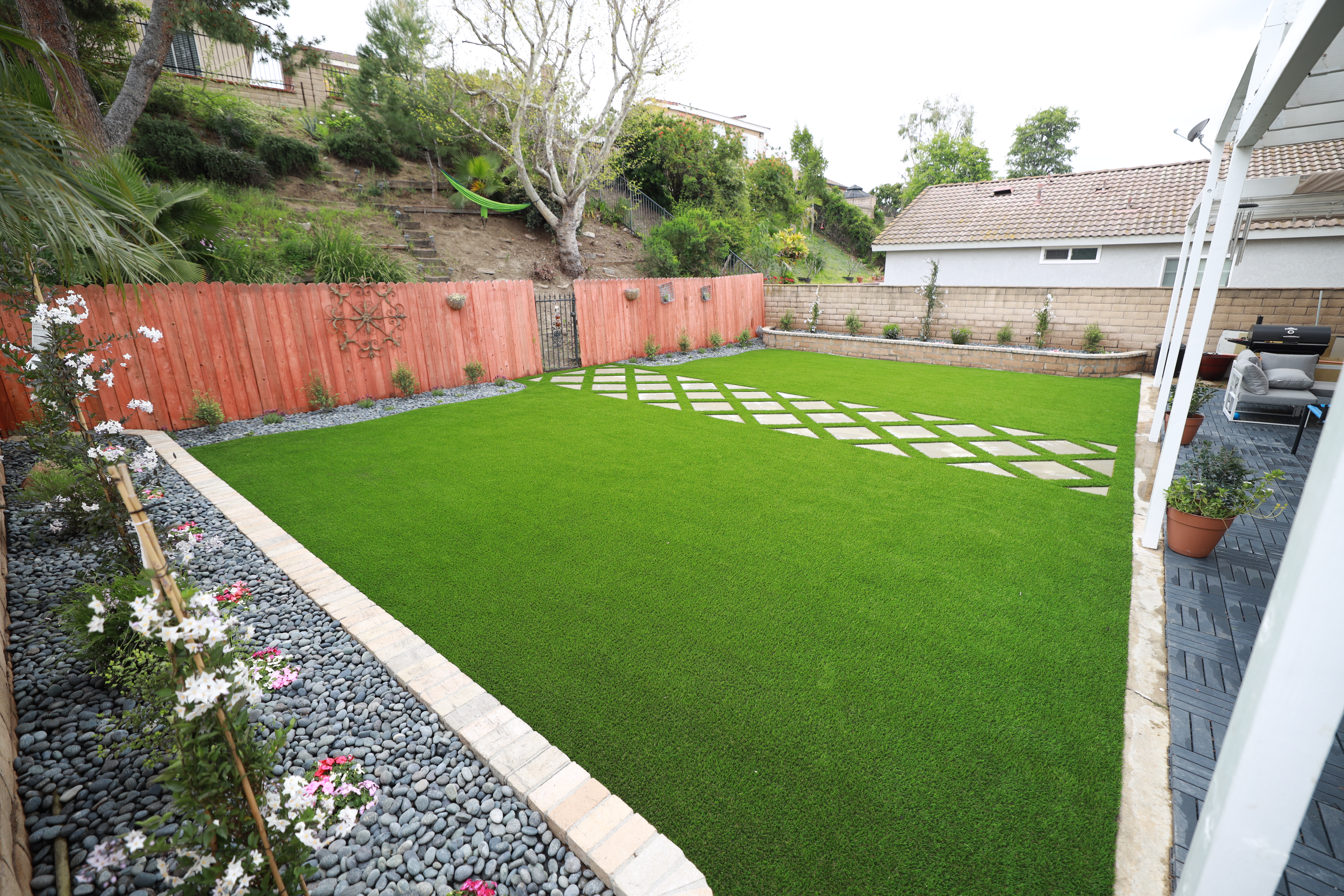 Beautiful residential backyard with freshly installed artificial turf