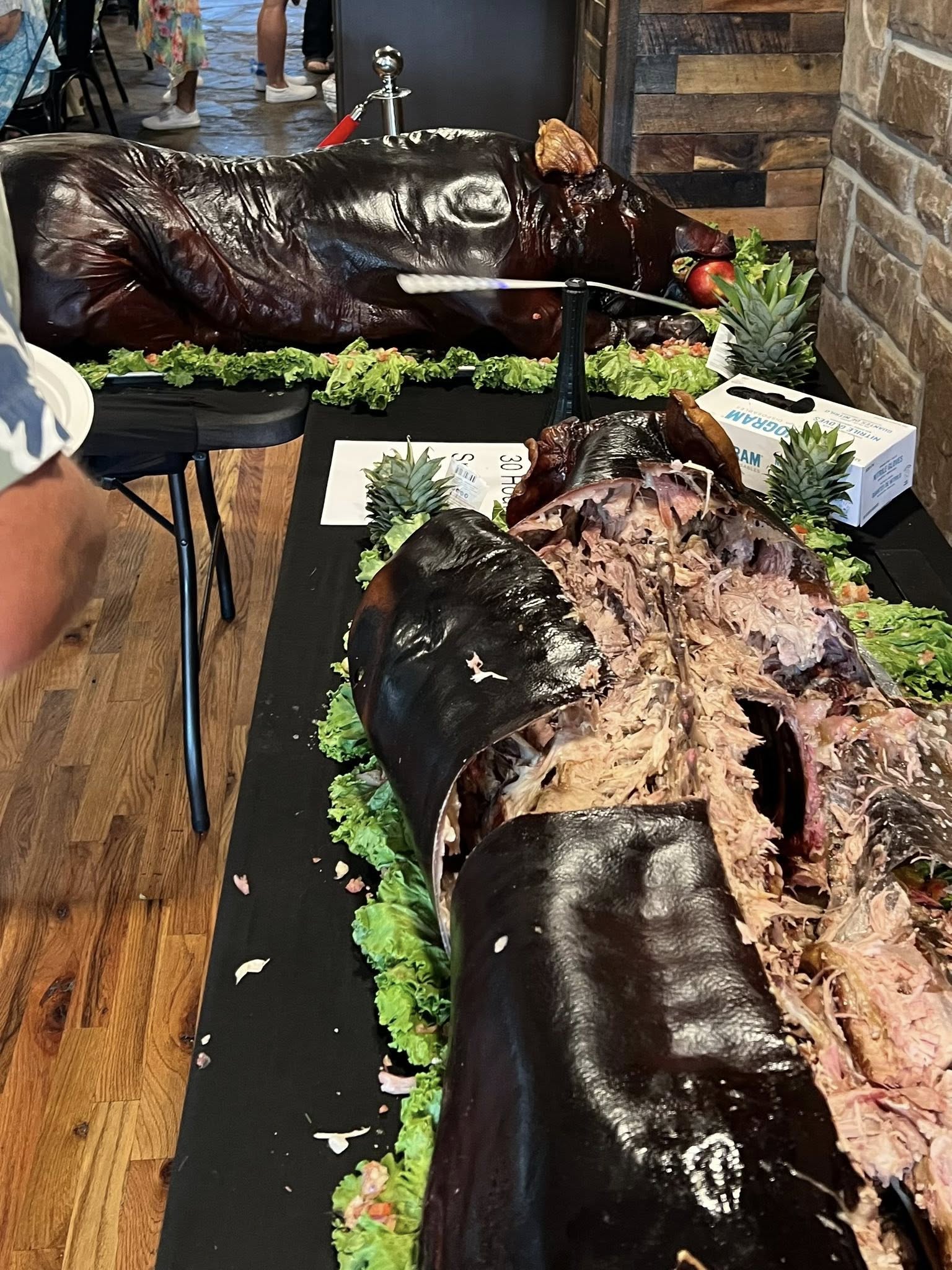 Plates of Hawaiian luau feast with pork, rice, and tropical sides