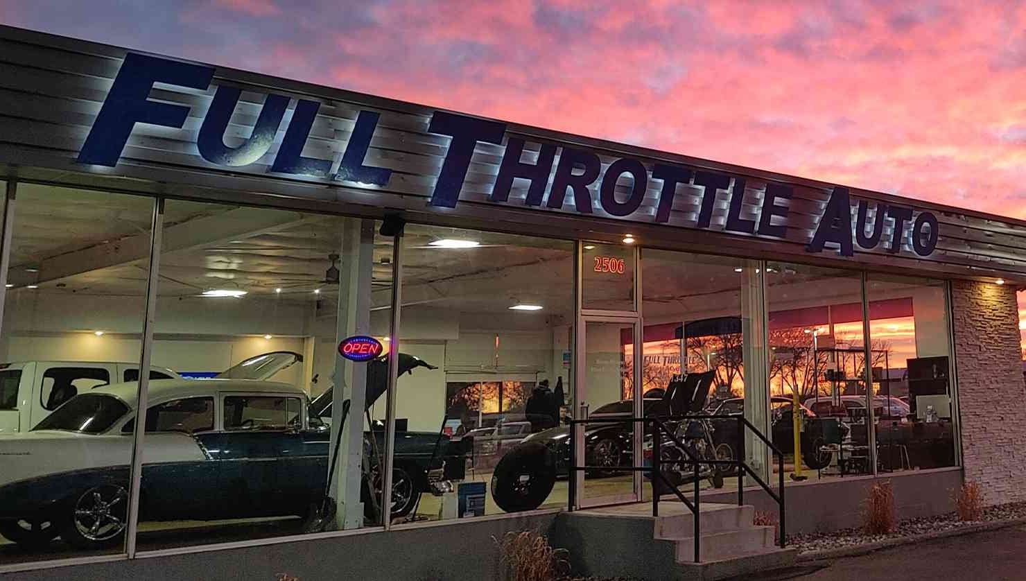 The Full Throttle Auto building on Phyllis Lane in Billings at sunset, with trucks lined up on the lot