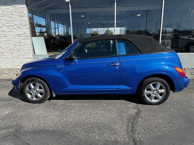 A blue Chrysler PT Cruiser convertible outside the Full Throttle showroom