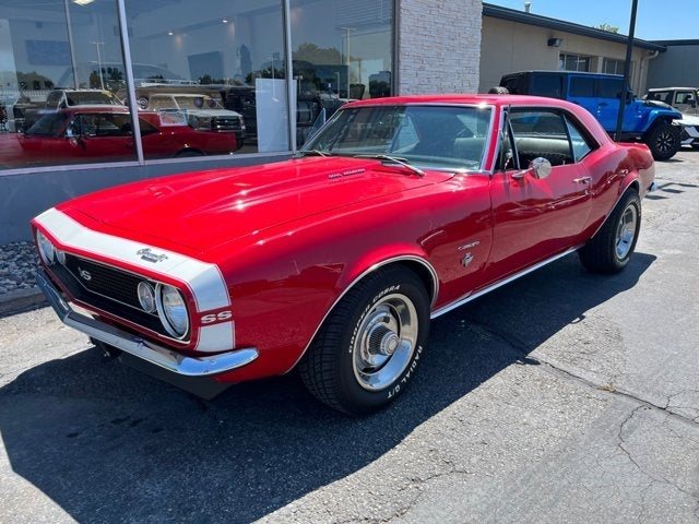 A red 1967 Chevy Camaro SS outside the Full Throttle showroom