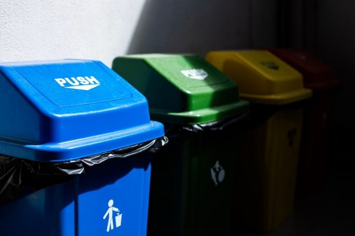 Color-coded recycling and waste bins lined up along the curb for trash service tucson.