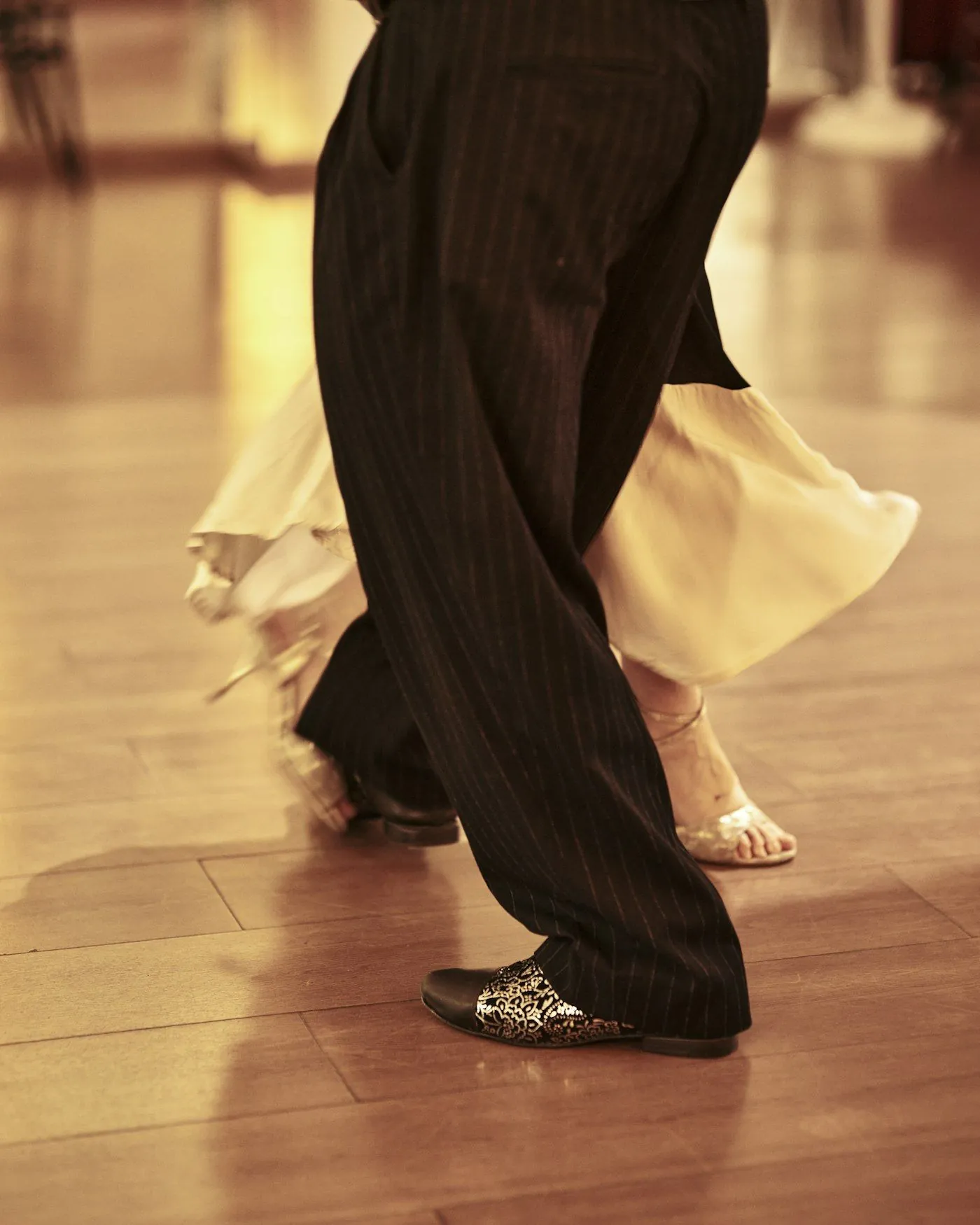 A couple’s feet mid-step during a ballroom dance