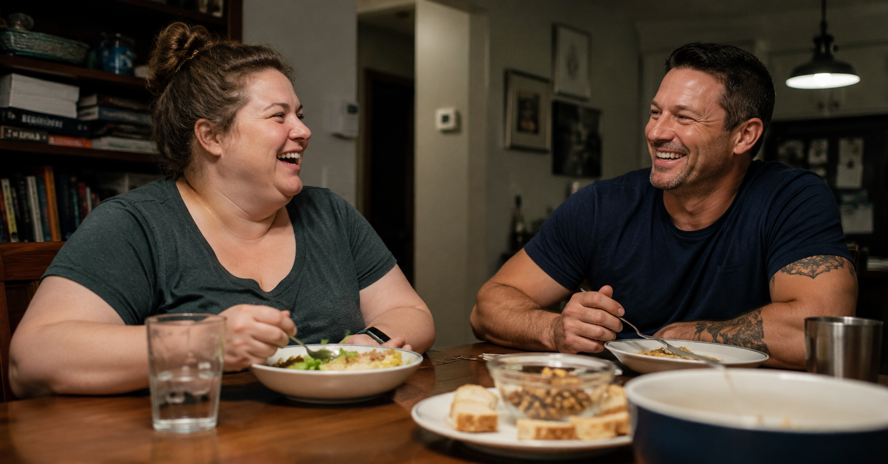 couple laughing over dinner at home after weight loss program