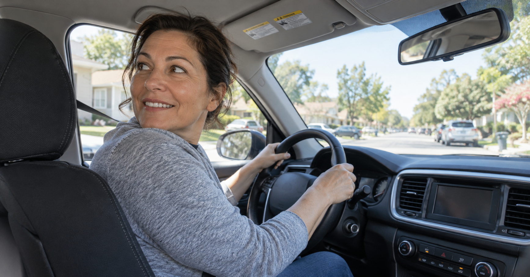 "Relaxed adult turning their head fully to check over their shoulder while driving, showing restored neck mobility after chronic neck pain treatment" "Relaxed adult turning their head fully to check over their shoulder while driving, showing restored neck mobility after chronic neck pain treatment"