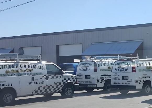 Competition A/C & Heat branded service trucks in San Marcos, Texas