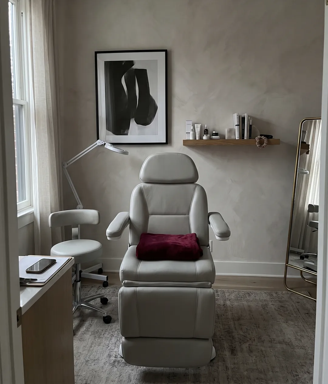 An empty treatment chair in a quiet med spa room at the end of the day