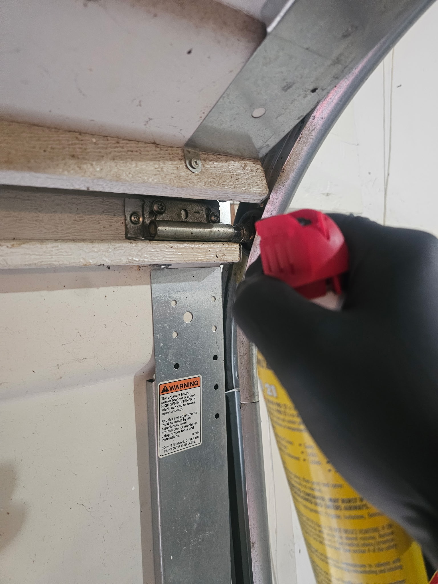 Garage door technician performing maintenance