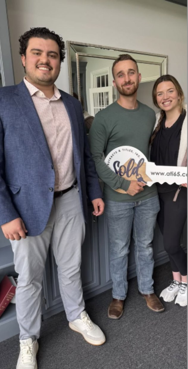 Brown home lending team celebrating with new homeowners after a successful home closing