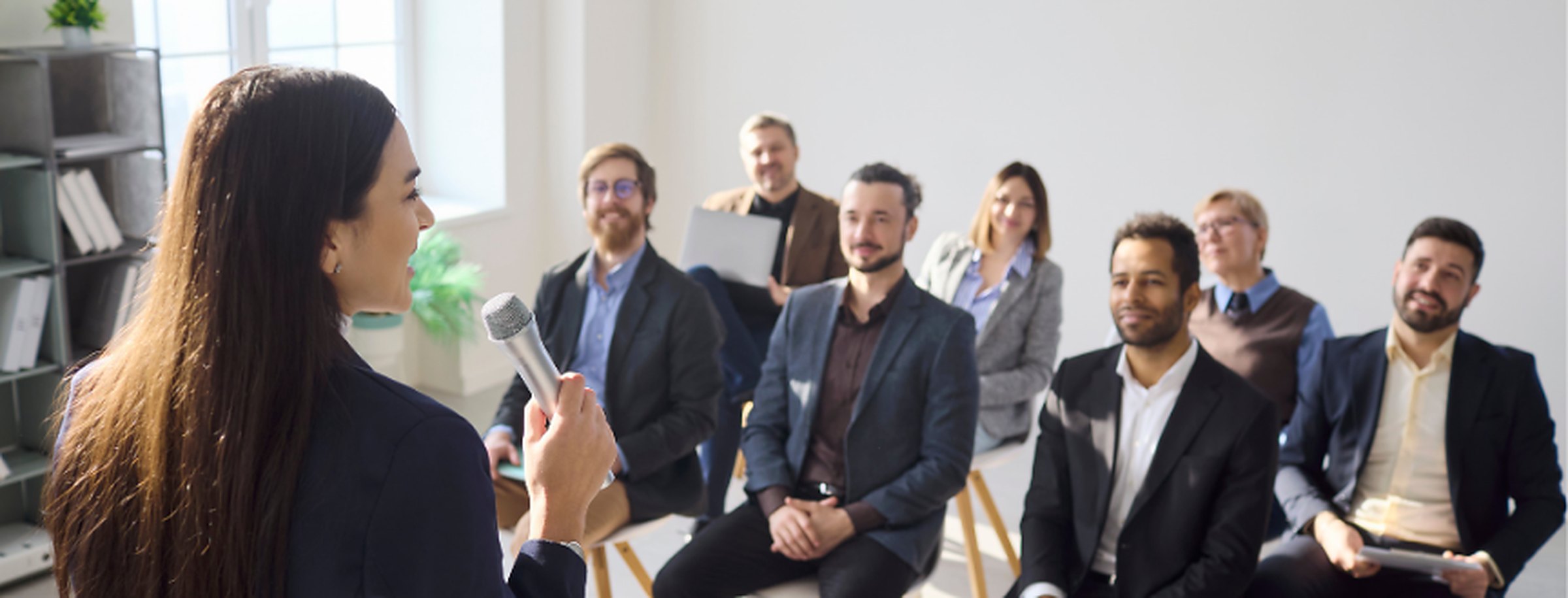 A stock image of a speaker talking to a group