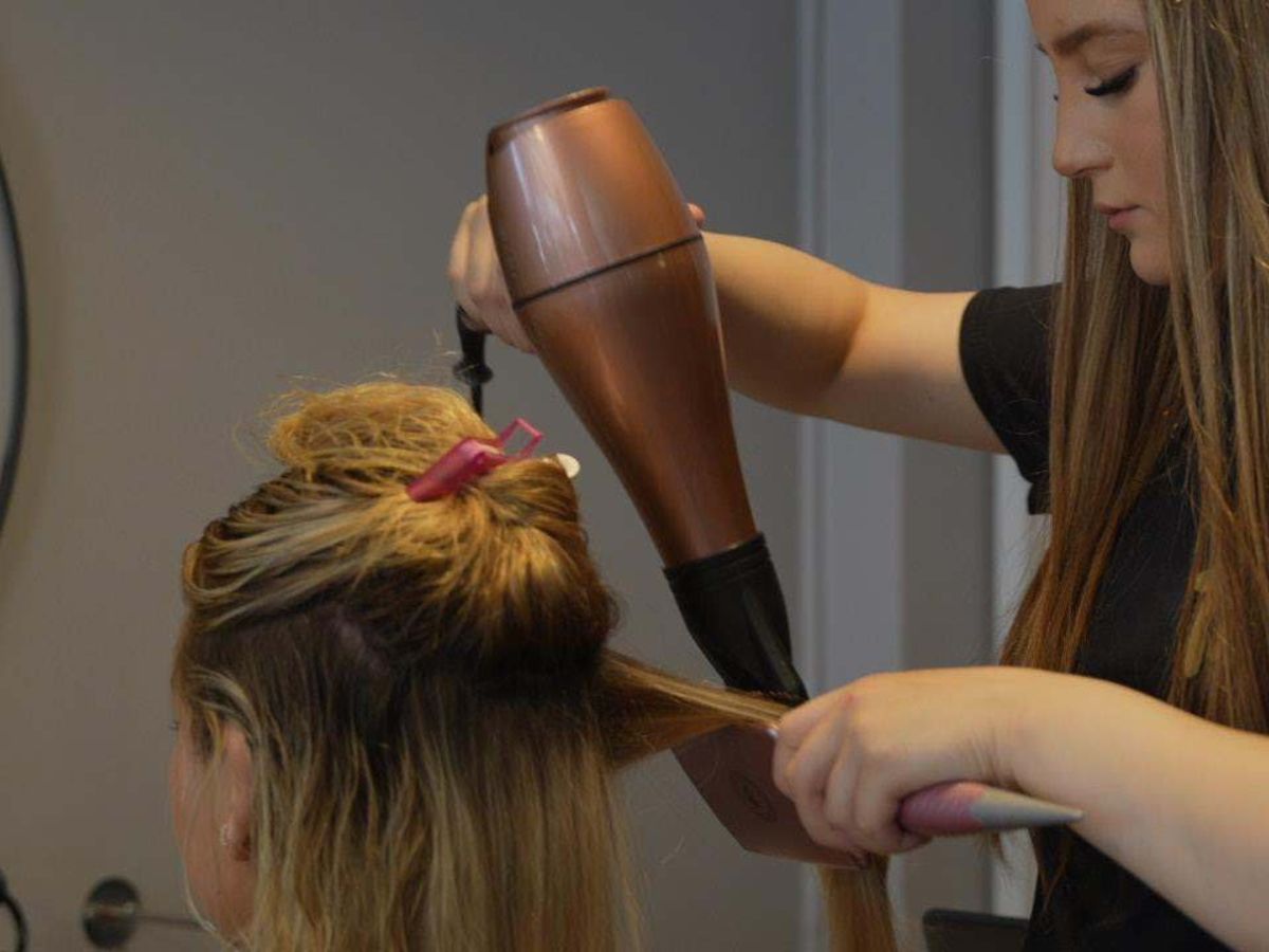 A TNB student working with a real client on the salon floor