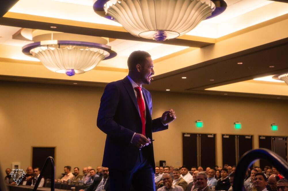 Ovi Vasquez on stage at a corporate keynote