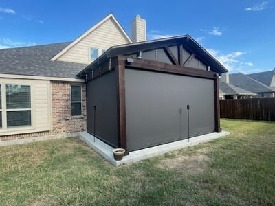 Enclosed patio space featuring privacy screens