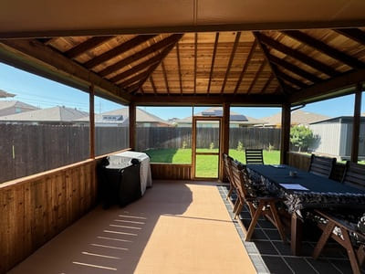 Spacious screened patio interior with wood ceiling