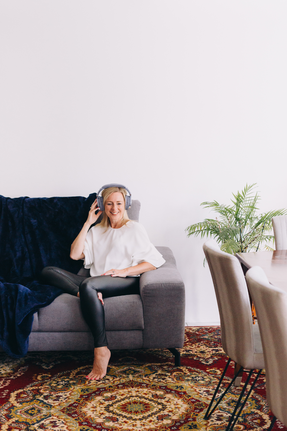 Woman smiling working on her laptop at a table