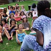 A big group of children seated outdoors at an African Beat kids' party