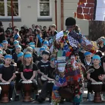 Primary school students seated with drums in a hall during an African Beat incursion