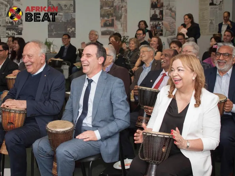 Guests at an Ethnic Communities' Council of NSW event playing djembe drums with African Beat