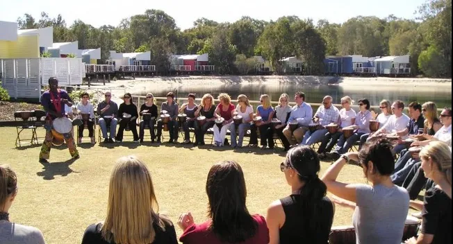 Corporate team building drum circle with African Beat outdoors