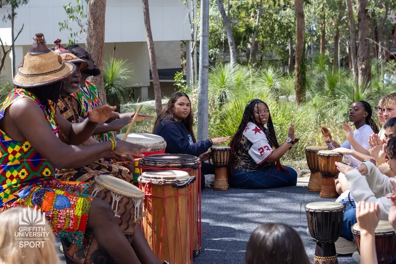African Beat drummers performing outdoors to a gathered crowd