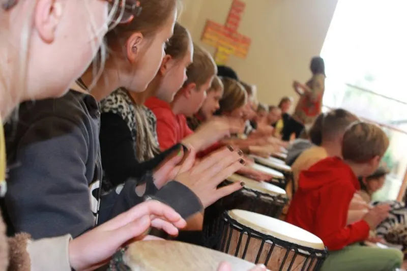 African drumming workshop with students drumming in a hall in Adelaide