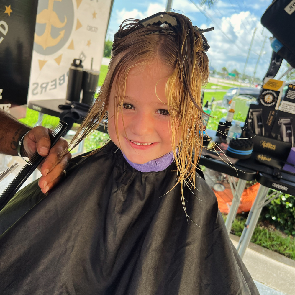 A child smiling with joy — the kind of moment a $5 gift helps create