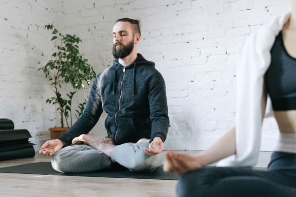 A person practicing trauma-informed yoga and mindfulness to reduce stress and reconnect with their body.