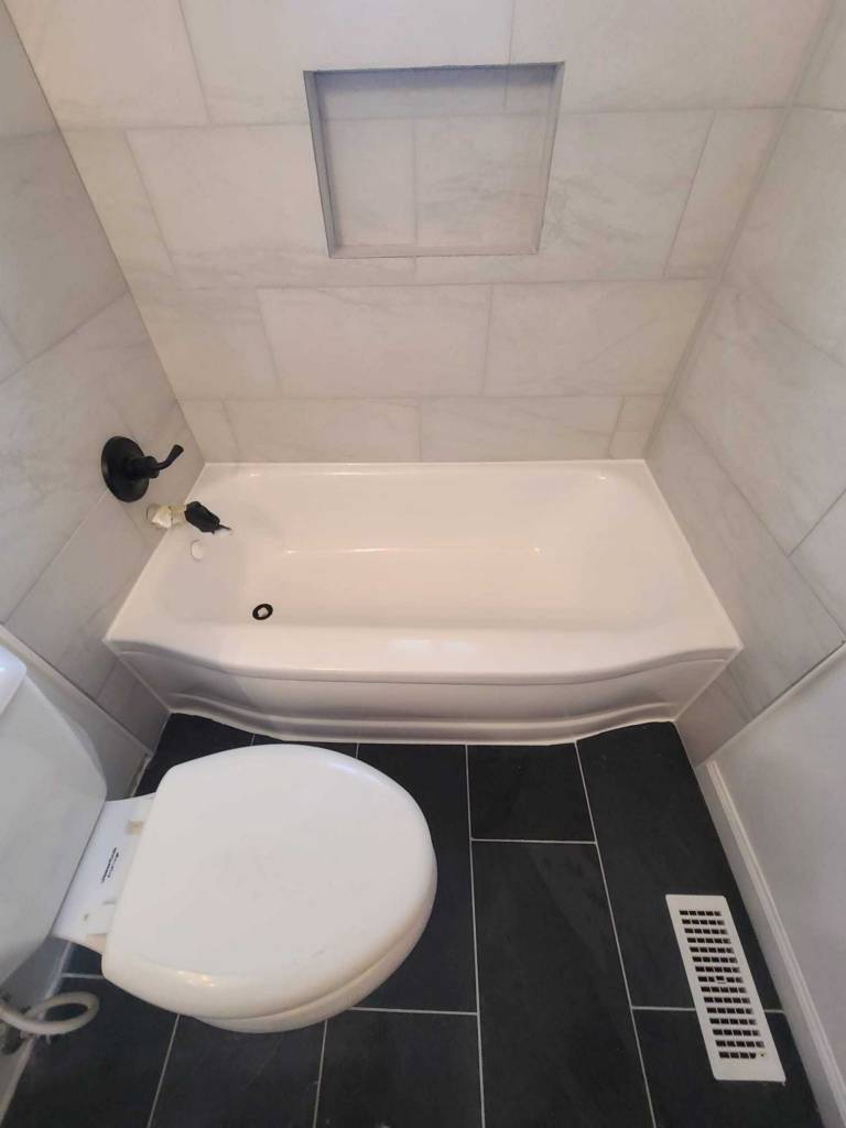 Worn residential tub being professionally refinished in Richmond
