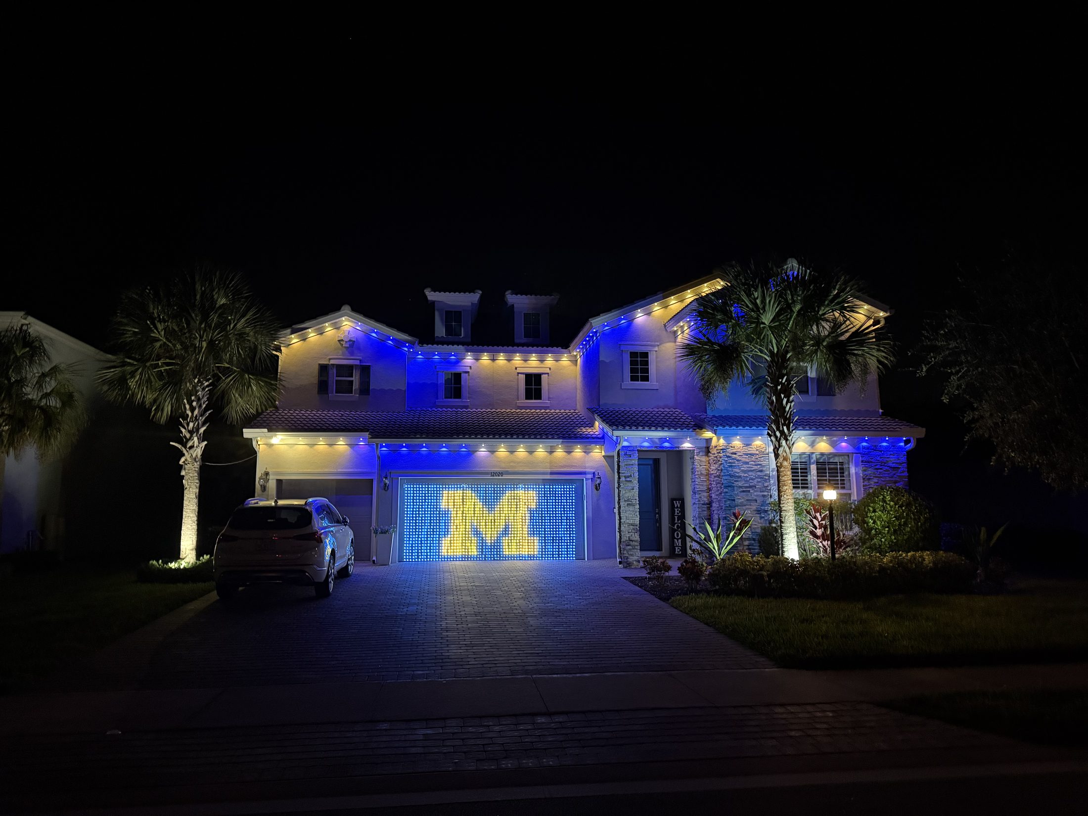 Permanent LED roofline lighting on a Bradenton home at night