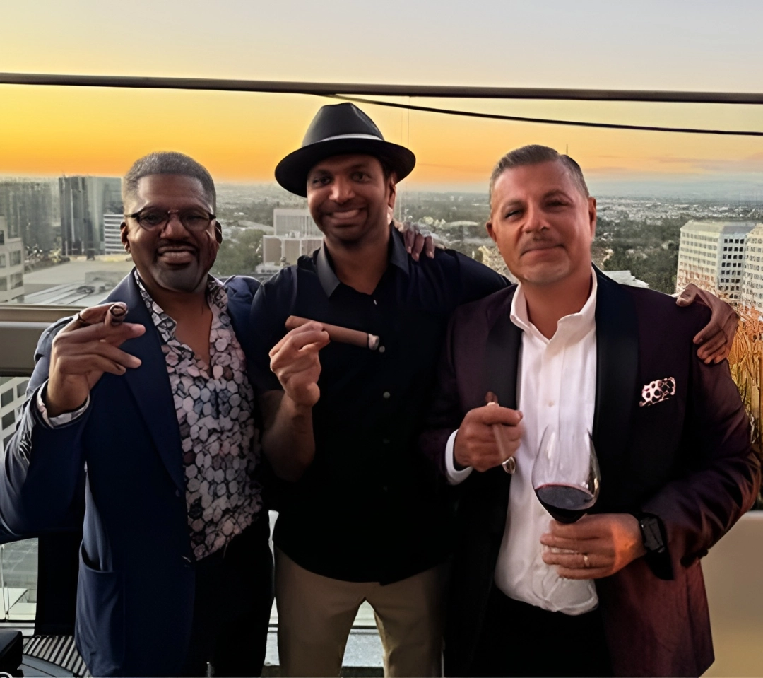 Bond Society founders enjoying cigars on a rooftop at sunset