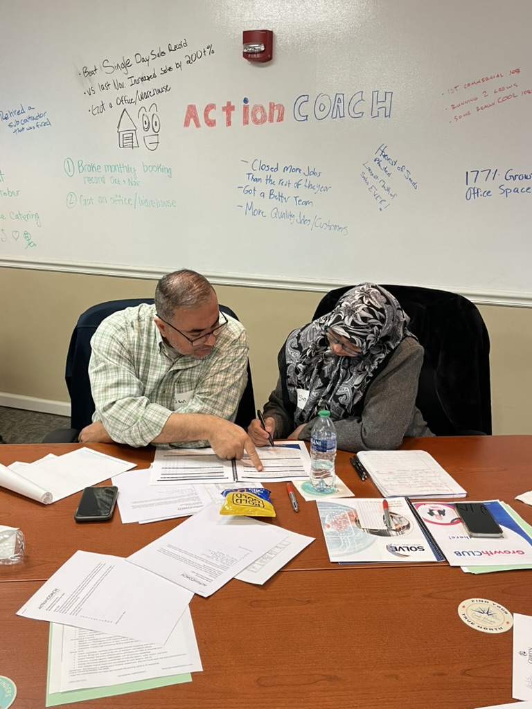 Two business owners working through their 90-day plan at GrowthCLUB