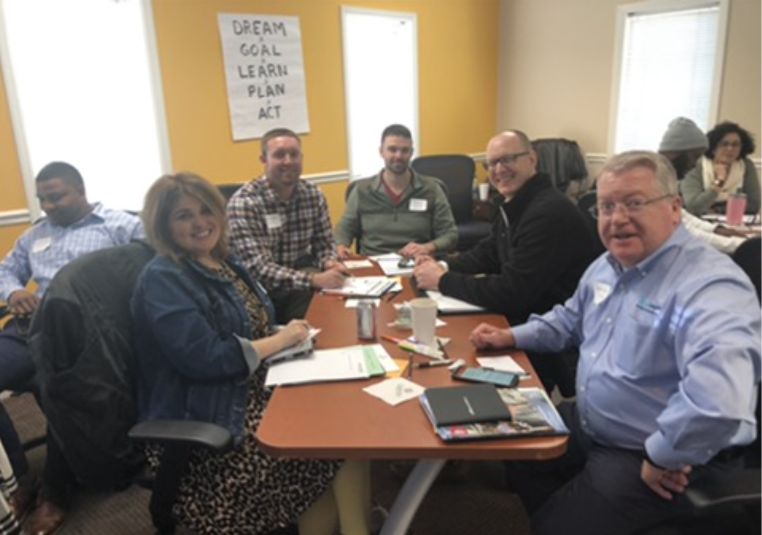 A table of business owners working through their plans together at GrowthCLUB