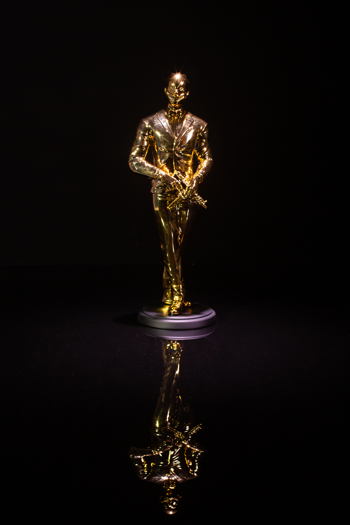 The Cuzzie trophy, gold, reflected on a black surface