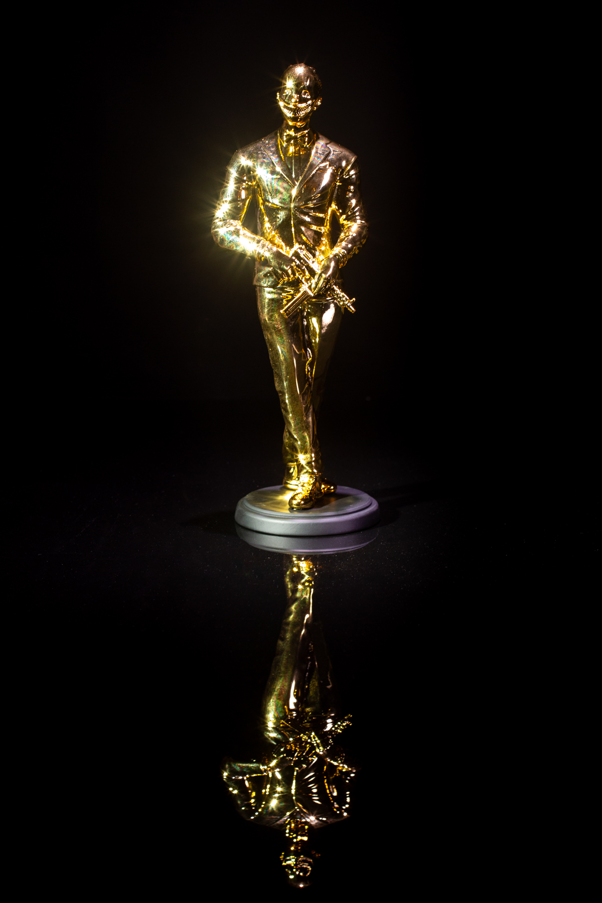 The Cuzzie, the GRRRD Awards trophy, standing on a black reflective surface