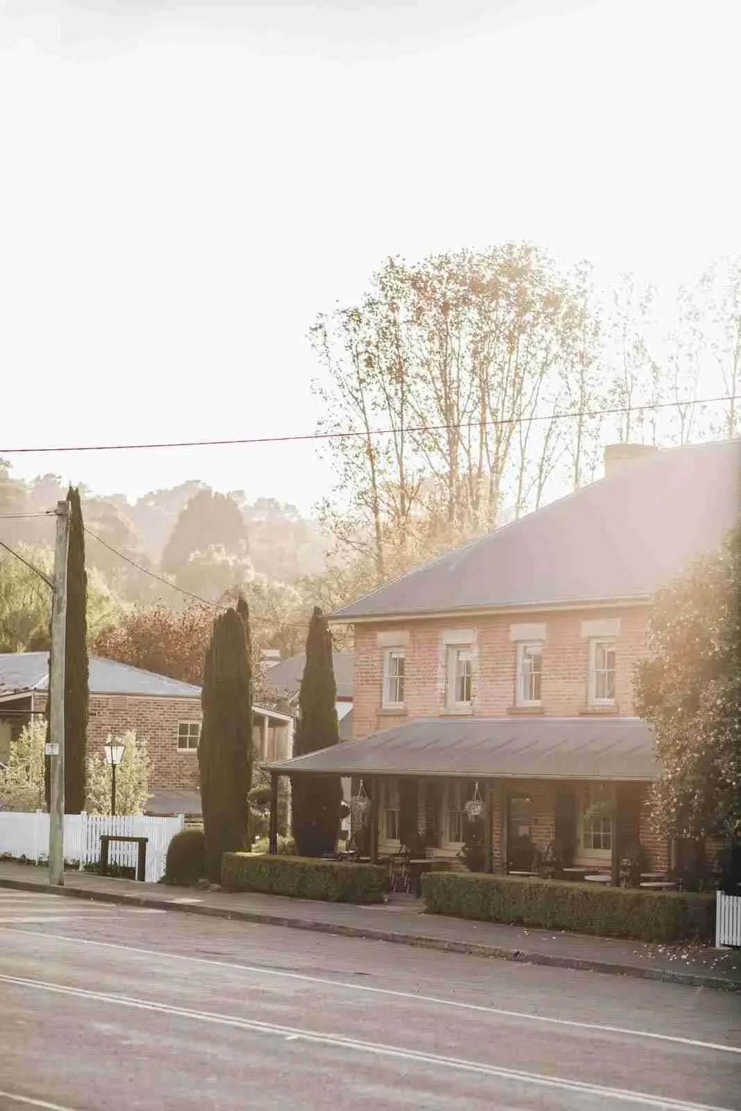 Sunlight over the historic brick frontage and verandah of Taylor’s Crown Inn in Berrima