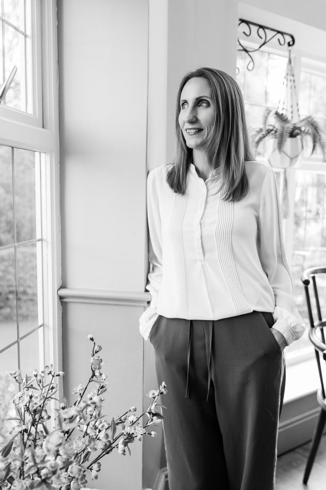 Beth in black and white by a window