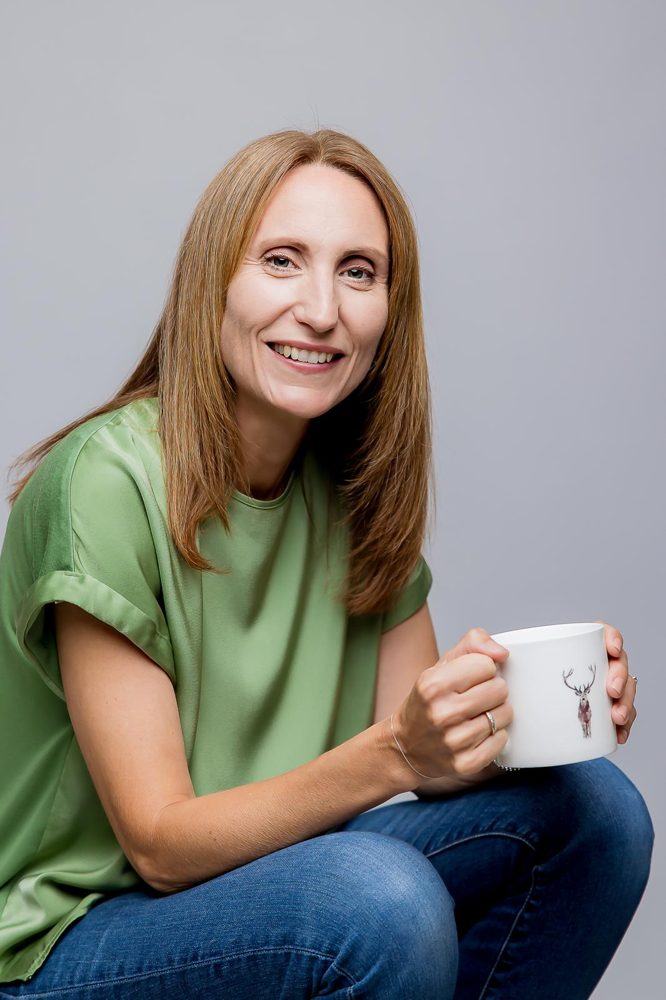 Beth Turner smiling with a mug