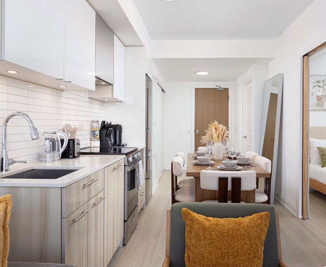 The galley kitchen with a full-size stove, looking through to the dining table