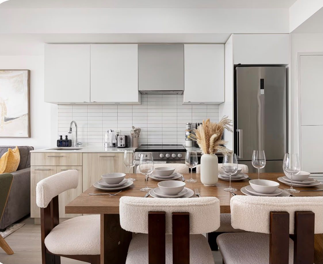 Dining table set for six in front of the galley kitchen