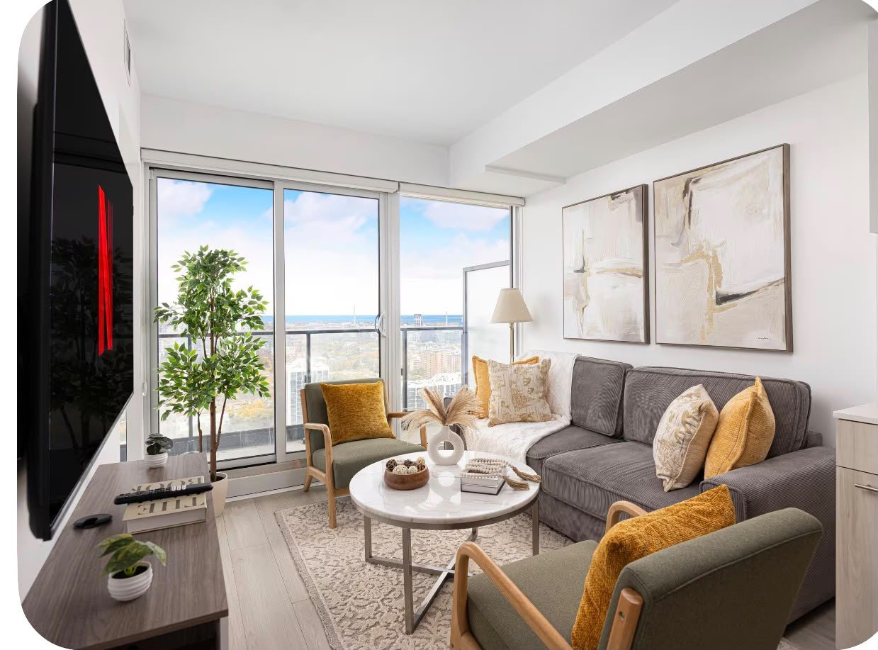 The living room with a sectional sofa and Lake Ontario on the horizon