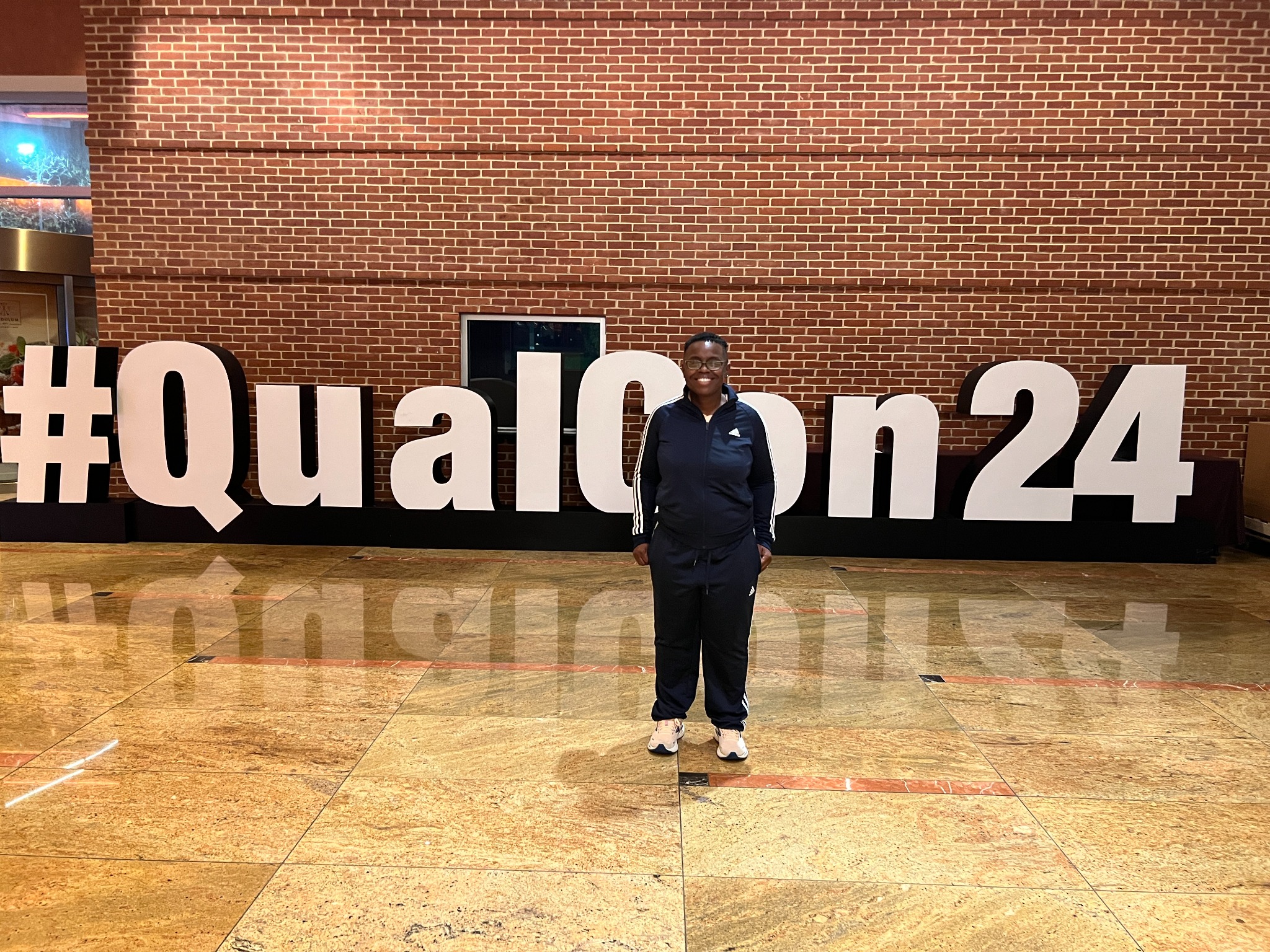 Rafat in front of the QualCon 24 display