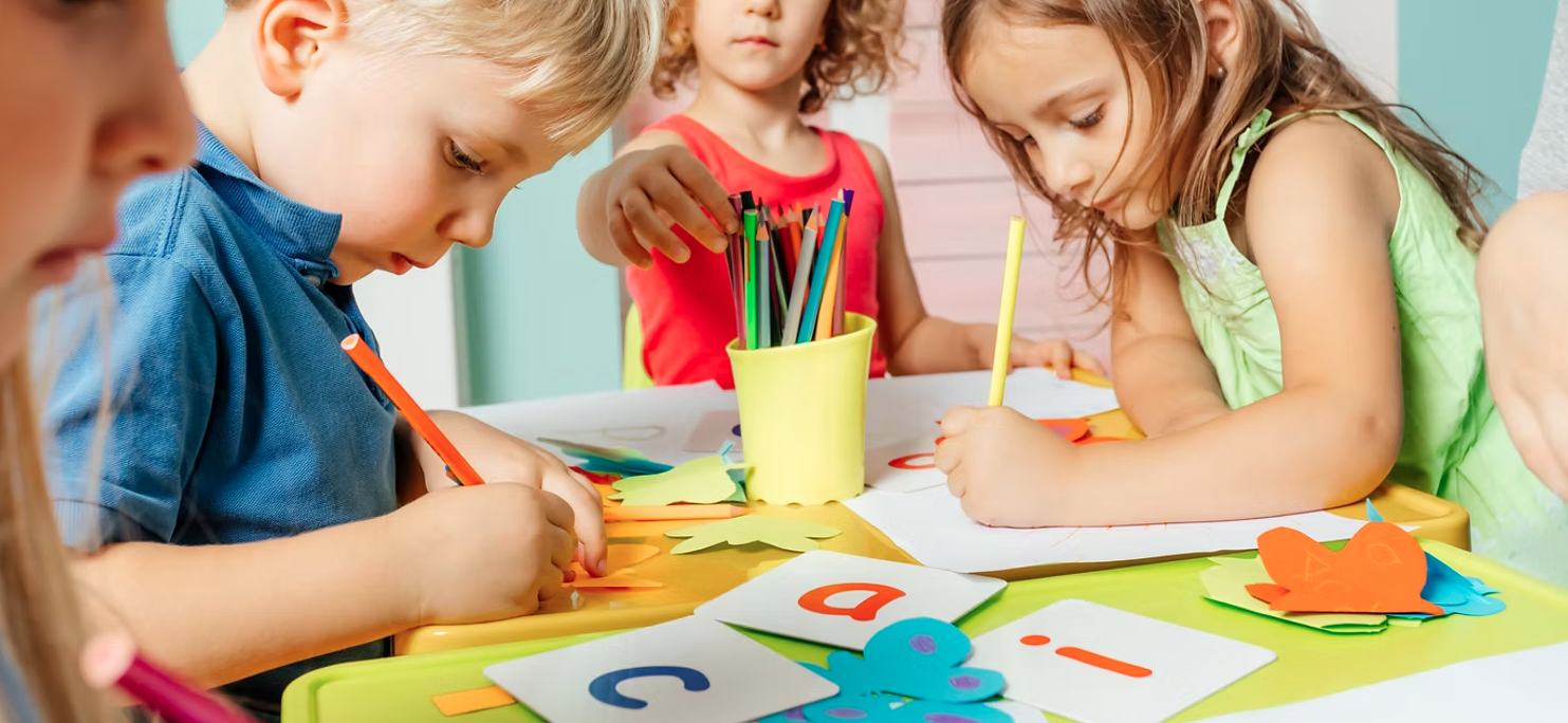 Happy diverse children learning and playing together in a bright, welcoming classroom at Blessed Generations Academy