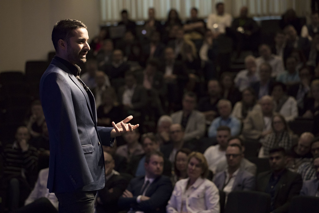 Sam Cawthorn presenting to a live audience