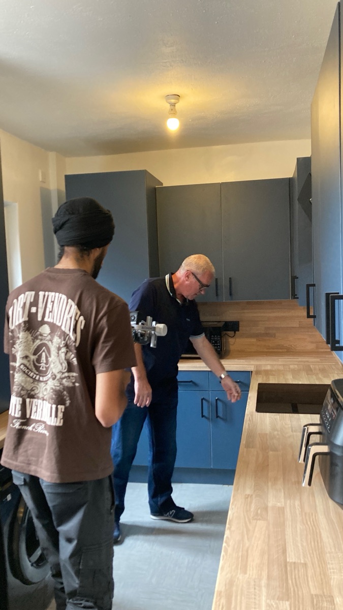 Client walking through a finished kitchen with the ScaleUp Digital team