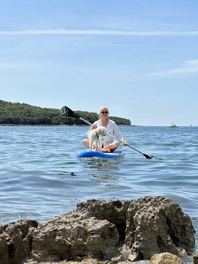 Ludwig fährt auf einem Stand-up-Paddle-Board mit aufs Wasser